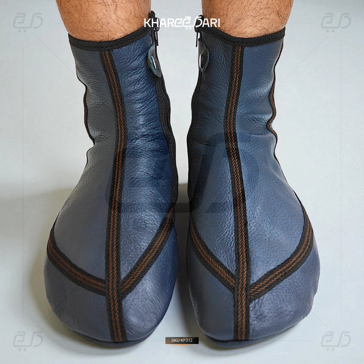 Blue leather ankle boots with brown stitching on a white background Blue