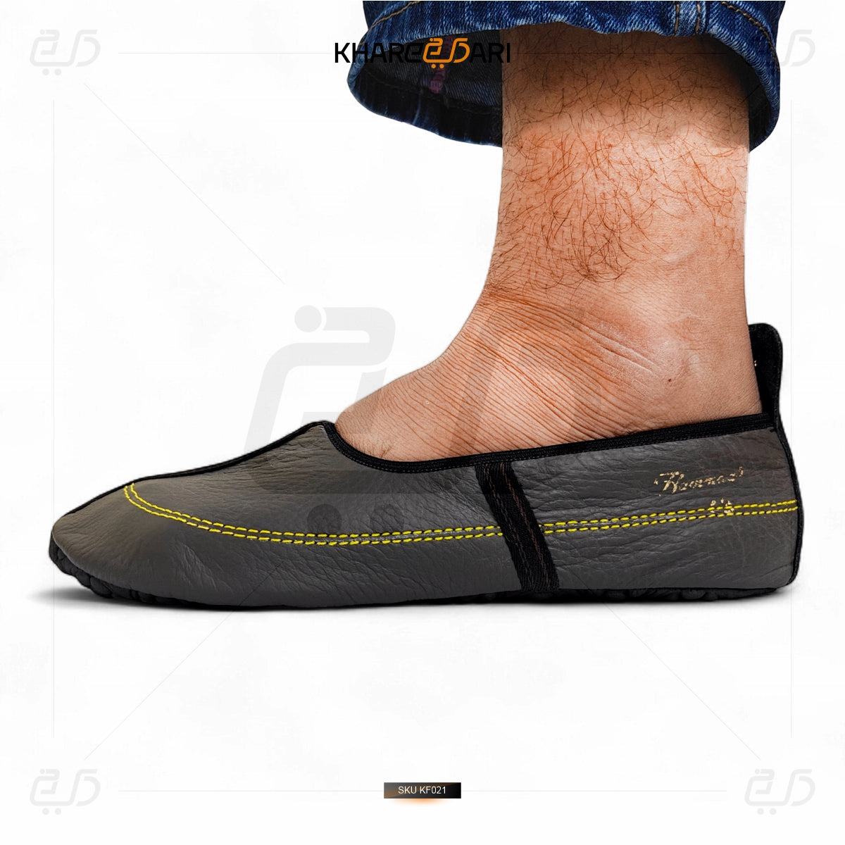 Black slip-on shoe with yellow stitching on a white background Dark Brown
