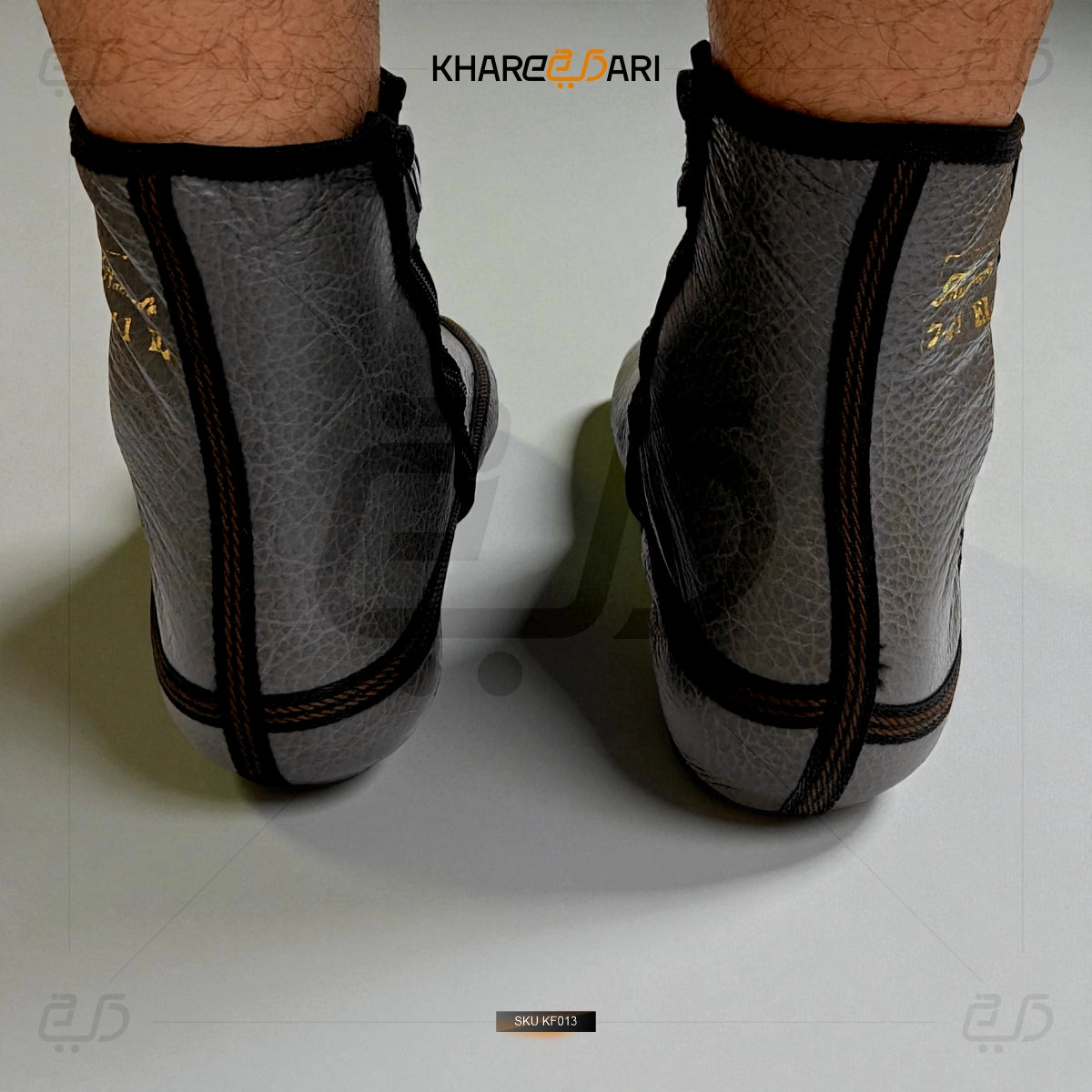 Gray ankle guards with black mesh and straps on a white background, branded 'Khareeb Dari'. Grey