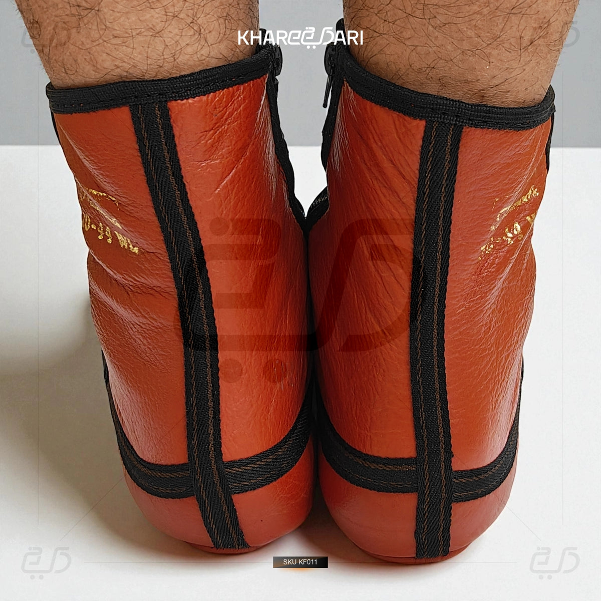 Red shin guards with black straps on a white background Red