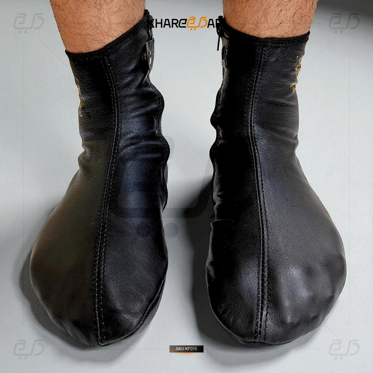 Pair of black leather boxing gloves on a light gray background