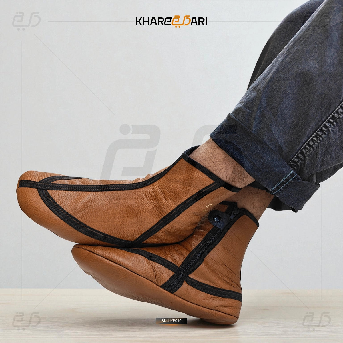 Brown leather shoes with black straps worn by a person, on a light background with 'Khareebari' branding. Brown