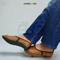 Brown leather shoes with black straps worn with blue jeans on a light gray background, featuring the brand 'Khareeb Dari'. Brown
