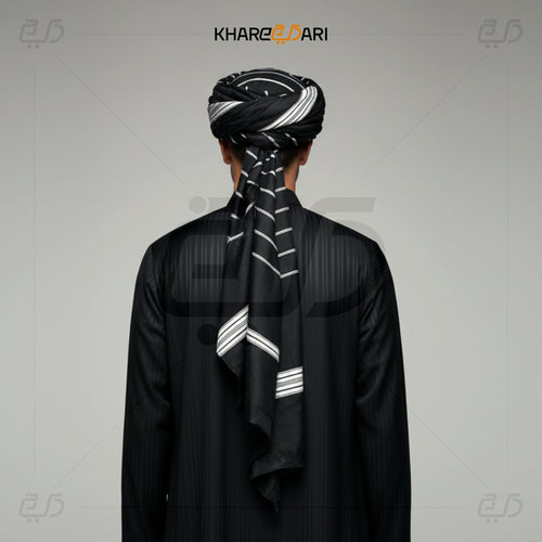 Person wearing a black traditional outfit with a matching turban on a gray background, branded 'Khareezdari'. Black with White Line