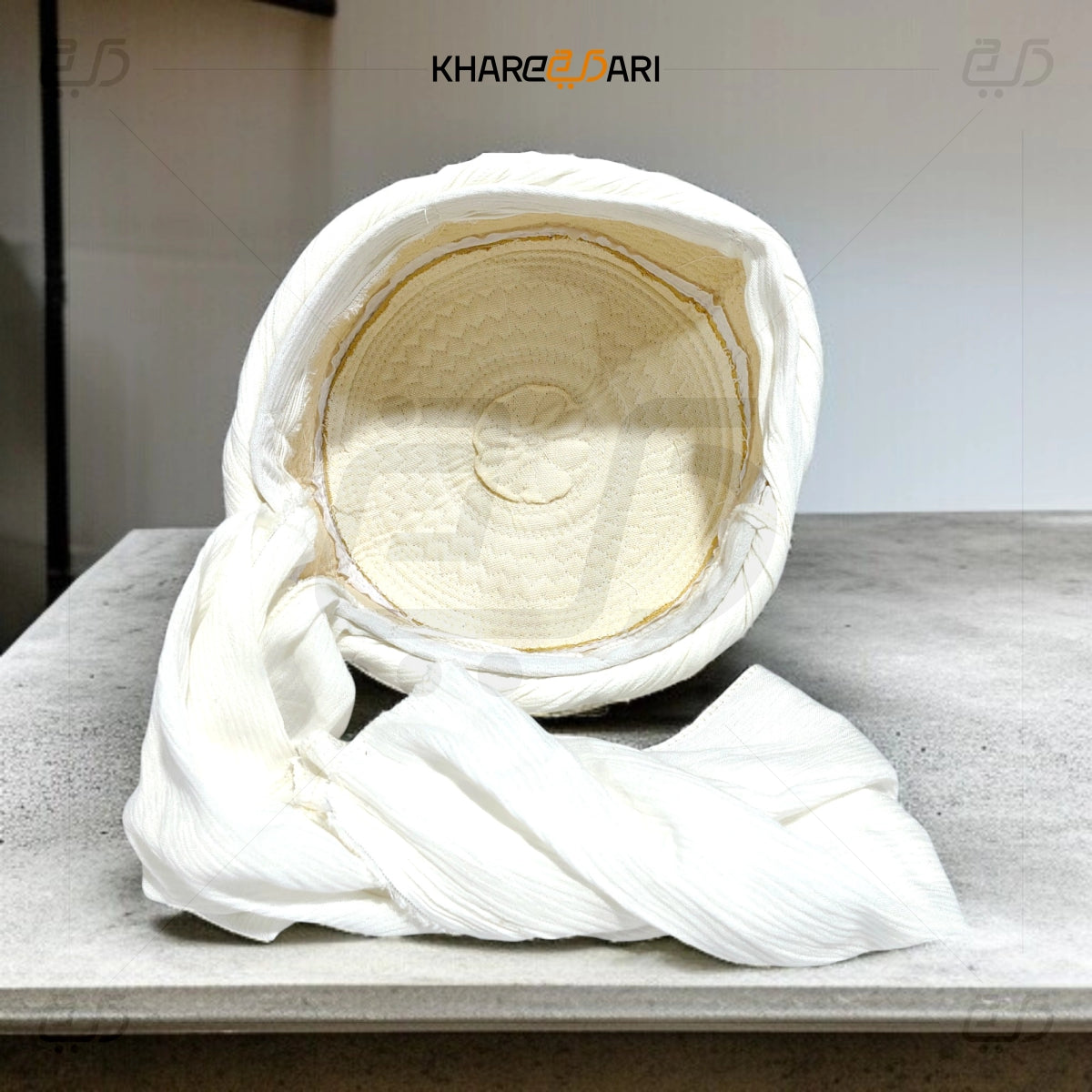 White fabric-wrapped product on a gray surface with 'KHAREZDARI' branding. White