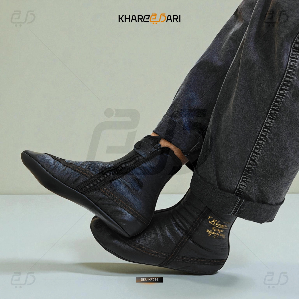 Black leather shoes worn with gray jeans on a light background, featuring the brand 'Khareeb Dari'. Purple