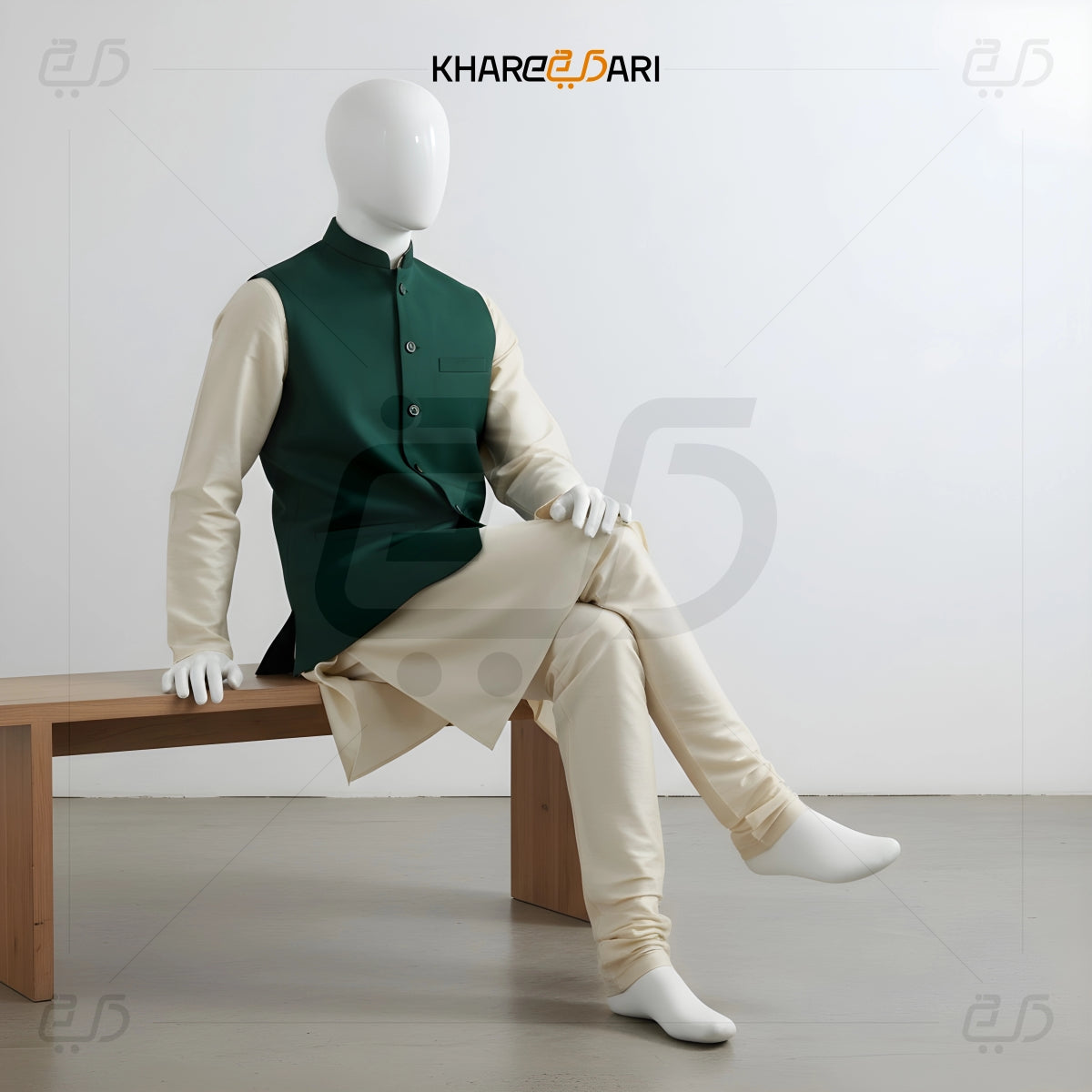 Mannequin wearing a green vest and beige pants sitting on a bench with 'Khareeb Dari' branding. Green