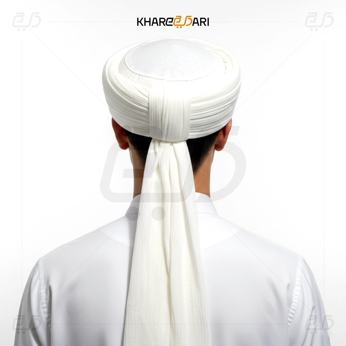 Person wearing a white turban with a long scarf, brand 'Khareeb Dari' visible. White