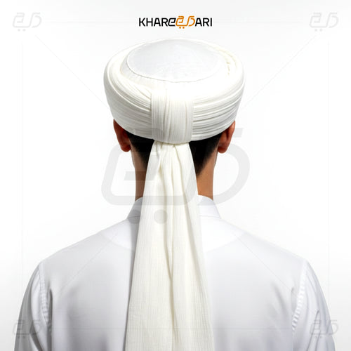 Person wearing a white turban with a long scarf, brand 'Khareeb Dari' visible. White