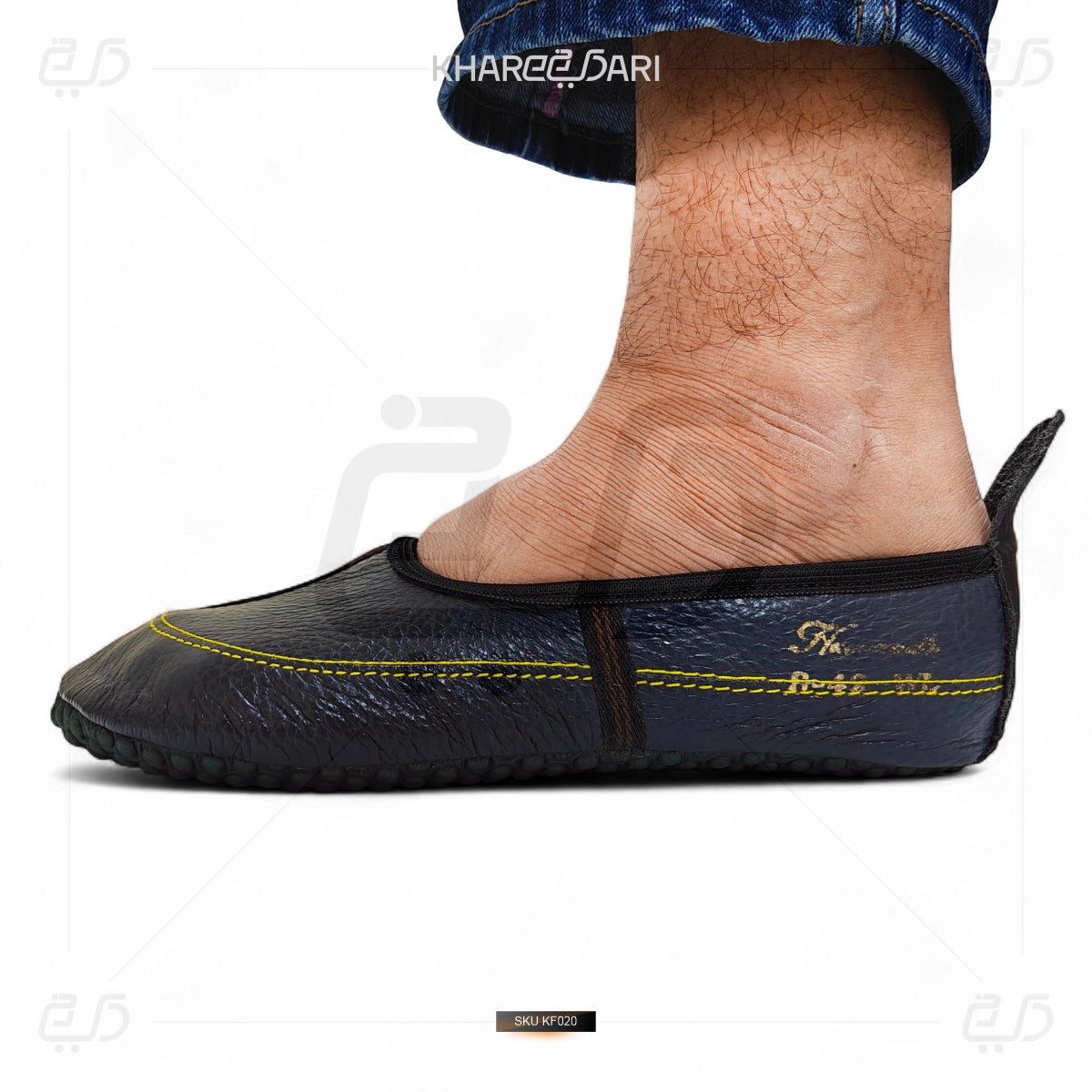 Black leather shoe with yellow stitching on a white background Purple