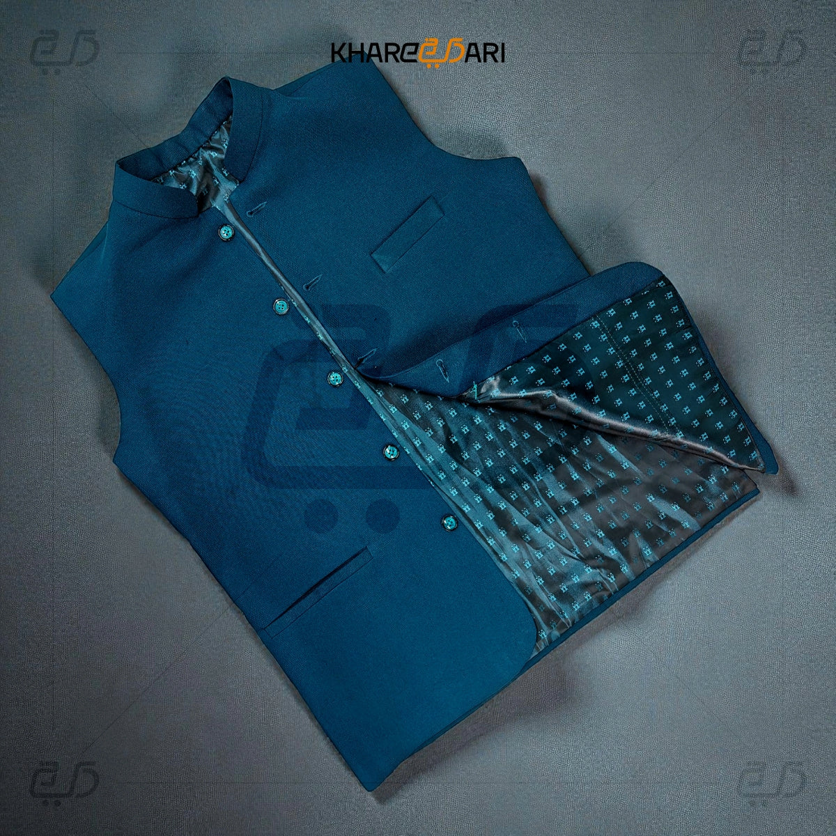 Blue jacket with patterned lining on a gray background, featuring the brand 'Khareeb Dari'. Navy