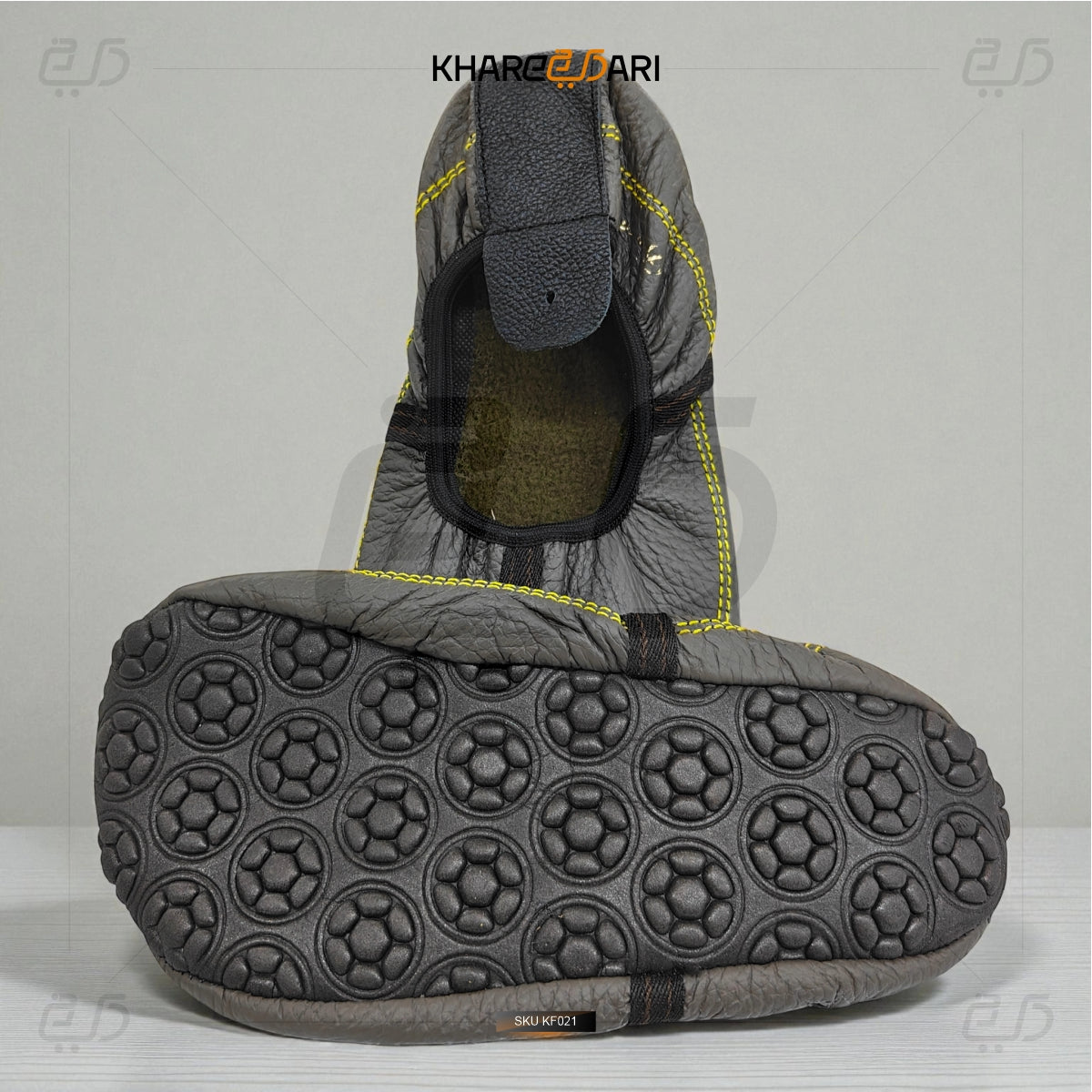 Gray shoe with textured sole on a light gray background, featuring the brand 'Khareej Dari'. Grey