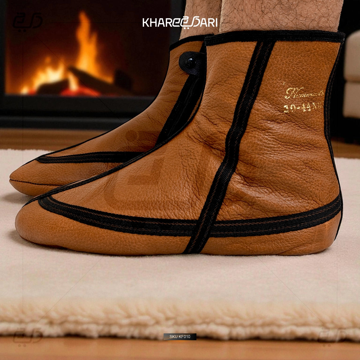 Brown leather slippers with black straps on a wooden floor in front of a fireplace. Brown