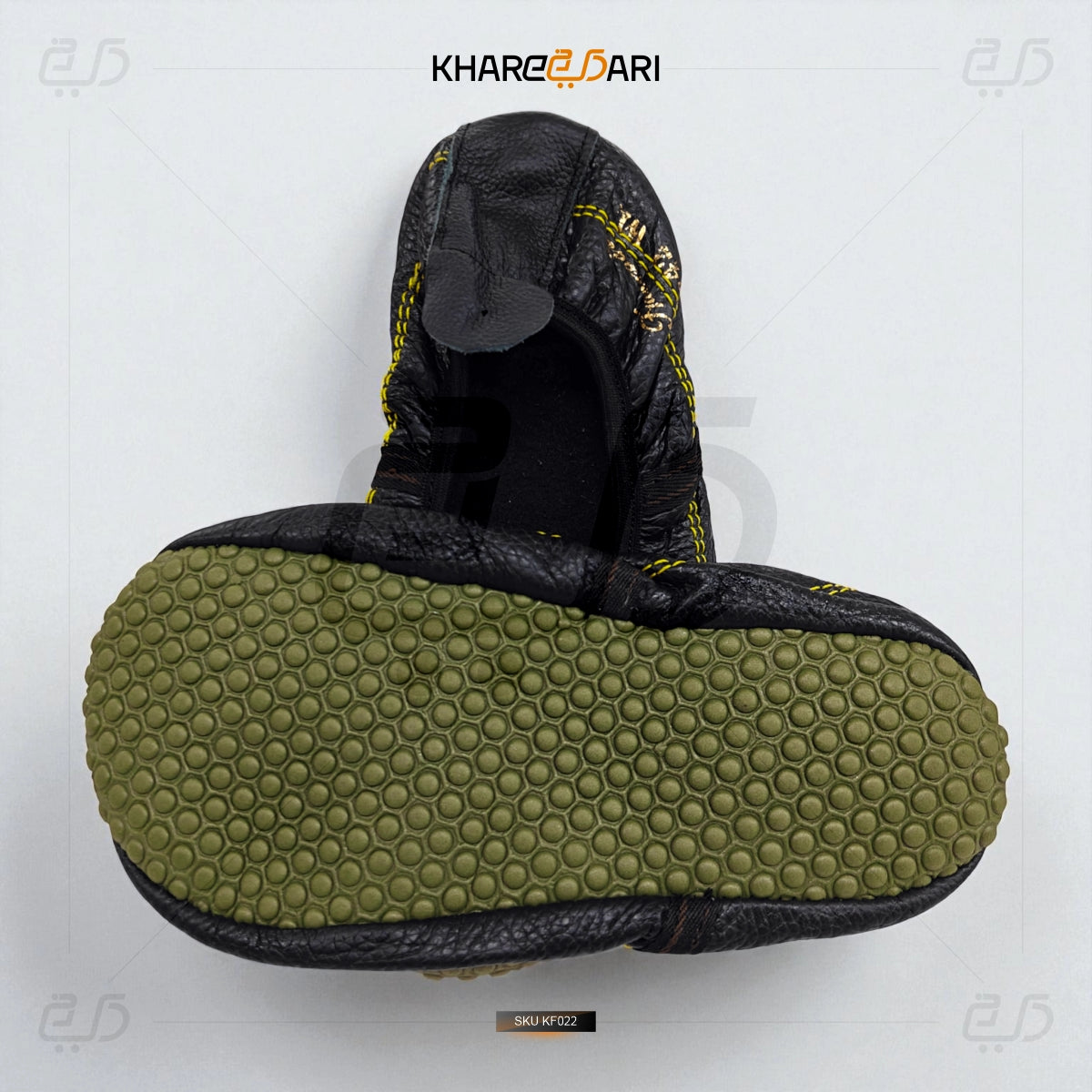 Black sandal with green sole on a white background, featuring the brand 'Khareeb Dari'. Black