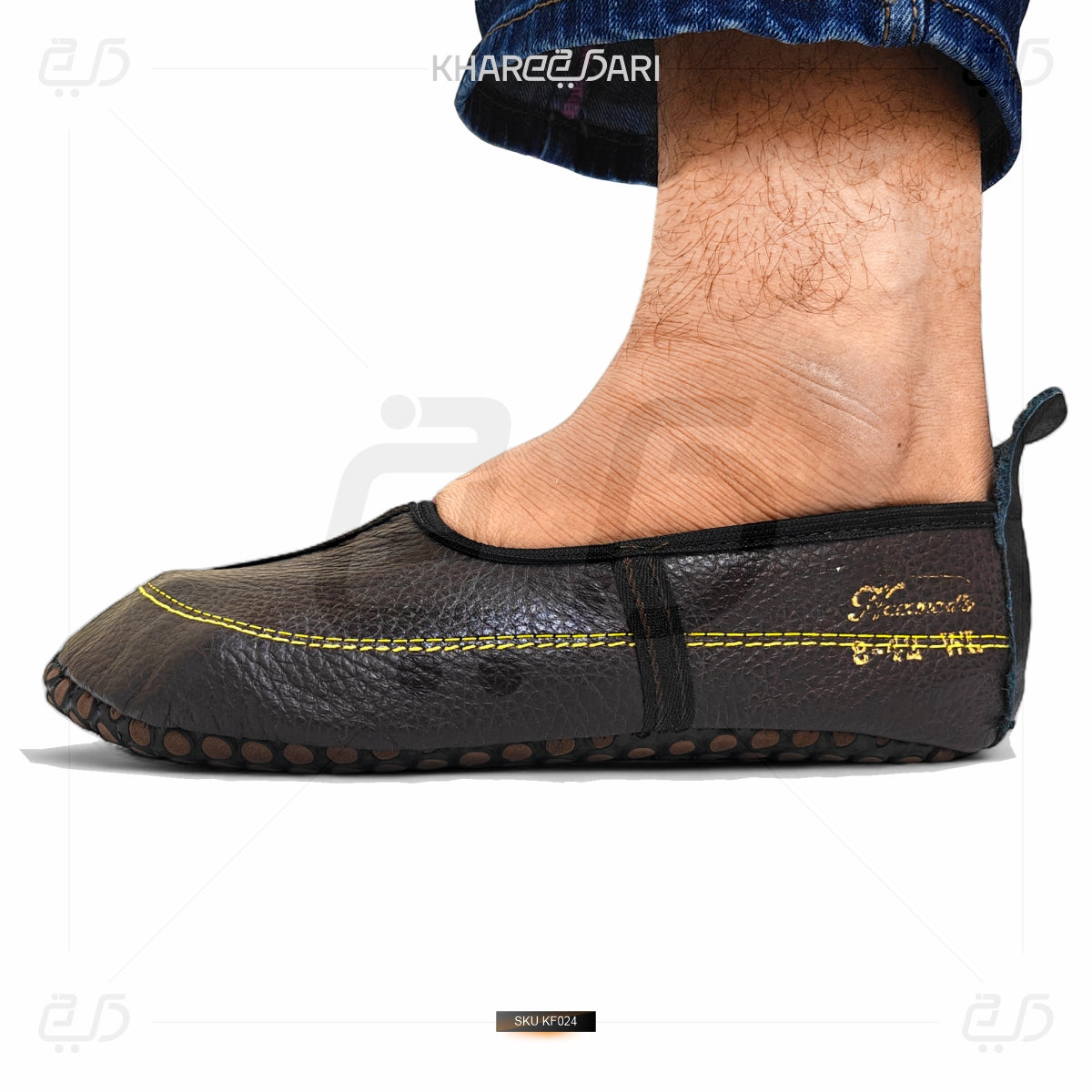 Black slip-on shoe with yellow stitching on a white background Dark Brown