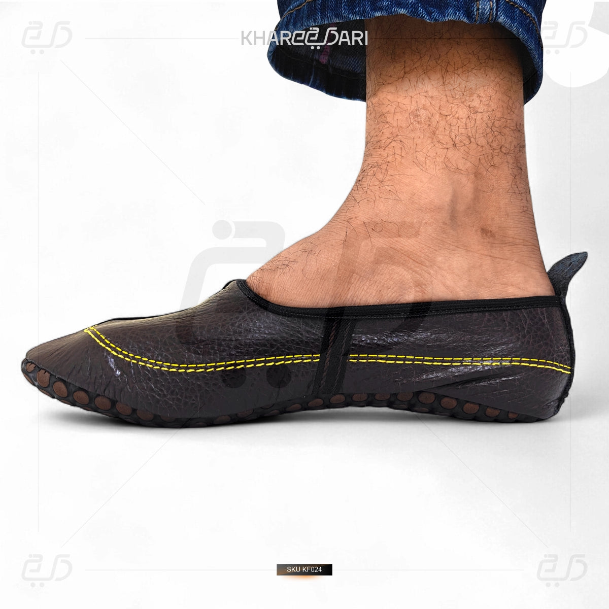 Black slip-on shoe with yellow stitching on a white background Dark Brown