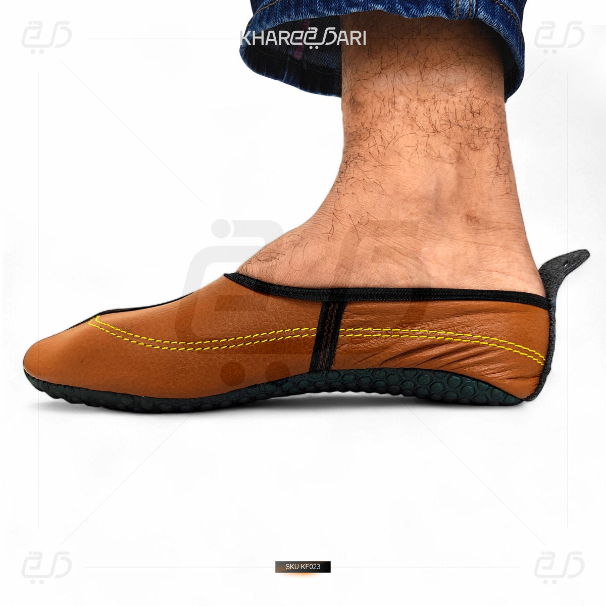 Brown slip-on shoe with yellow stitching on a white background Brown