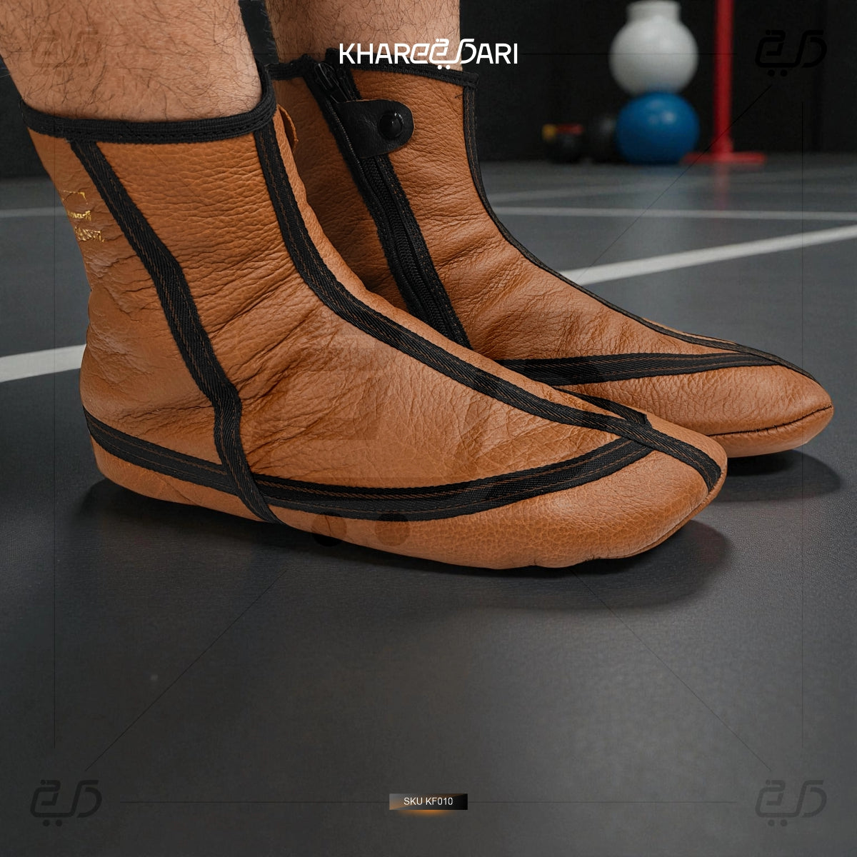 Brown leather shoes with black straps worn by a person on a dark floor. Brown